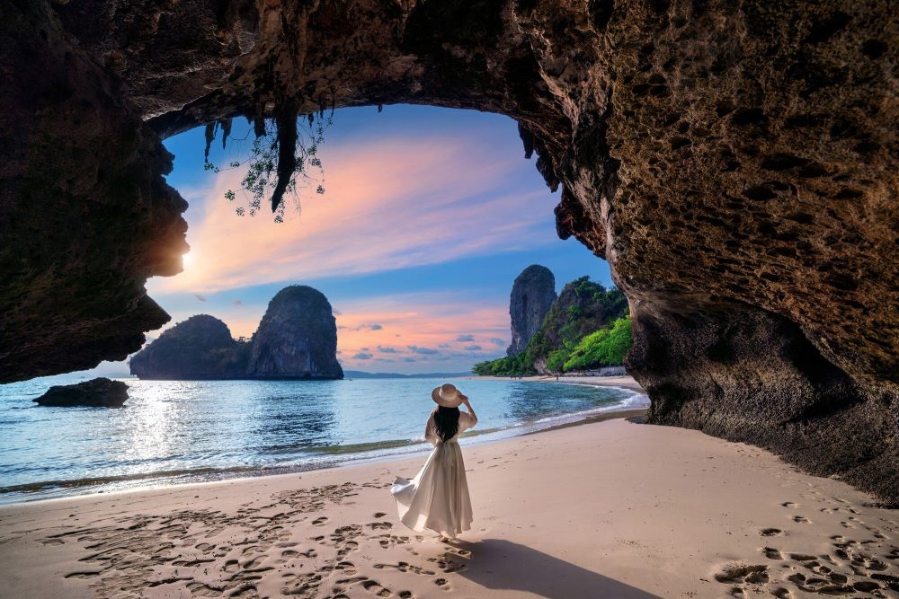 A girl walks on a picturesque beach in Thailand