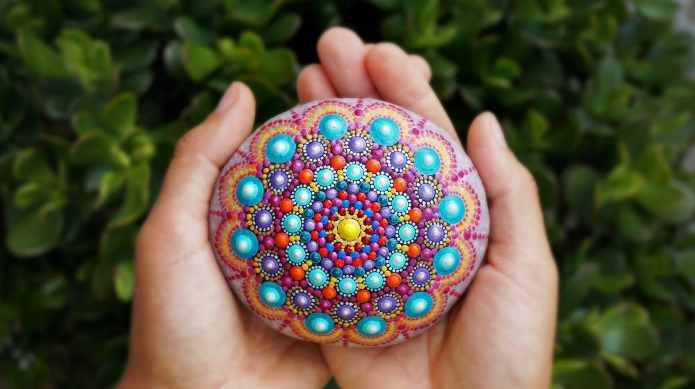 A beautiful round mandala made of stone in hand