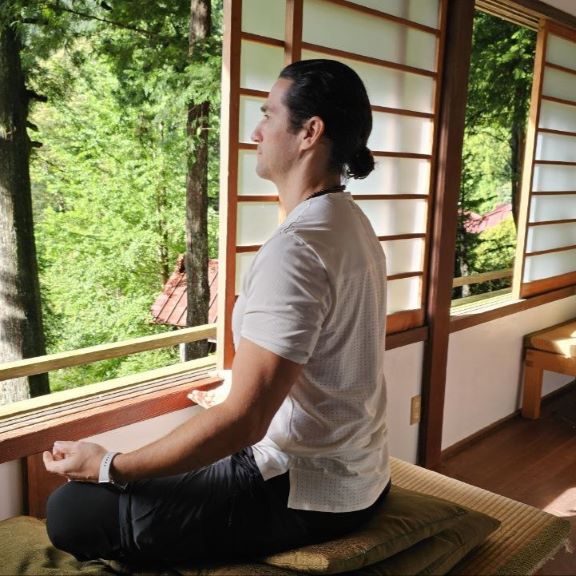 Teos meditates while looking out the window