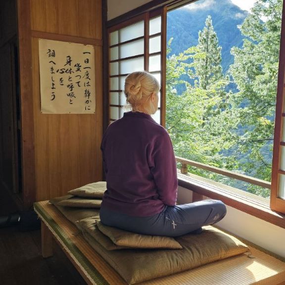 Olya meditates looking out the window