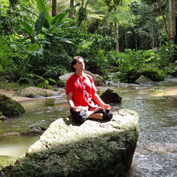 Roma meditates on a rock