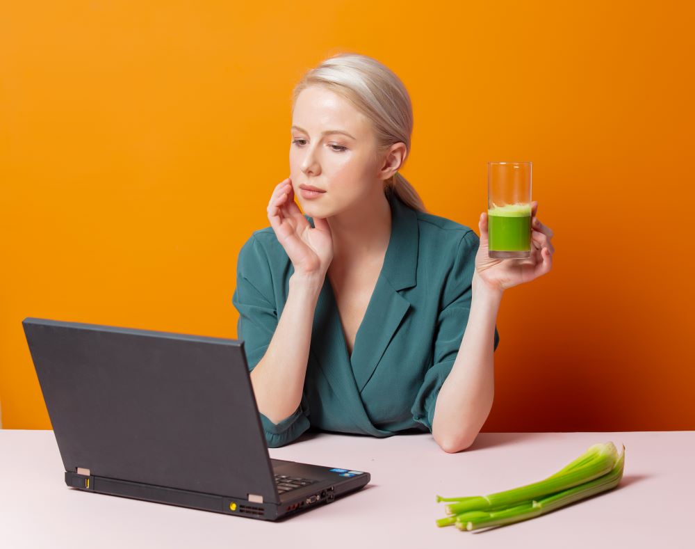 A girl reading about detox on the Internet