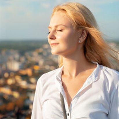 The woman with her eyes closed smiles quietly